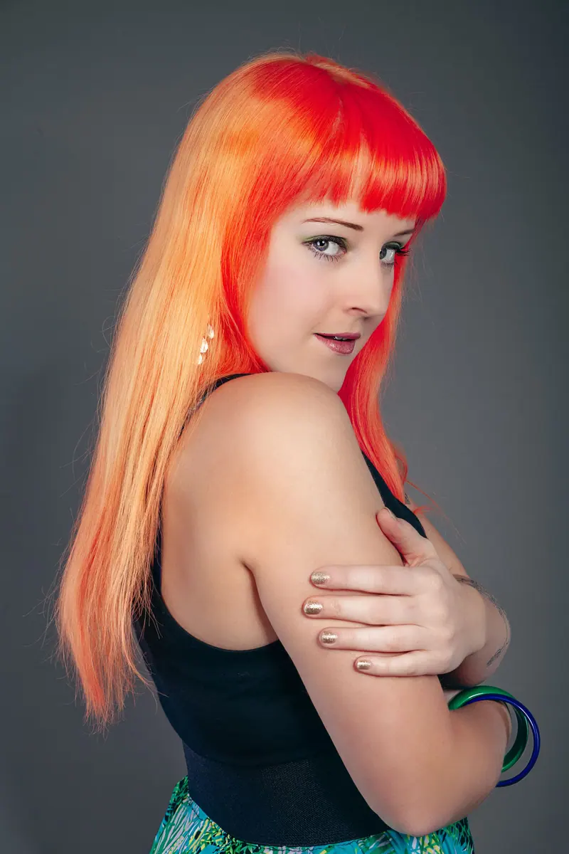 Long orange hair with a straight fringe over one shoulder