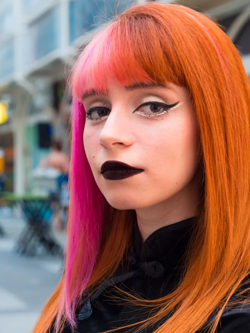 Orange hair with a hidden pink panel and a heavy fringe