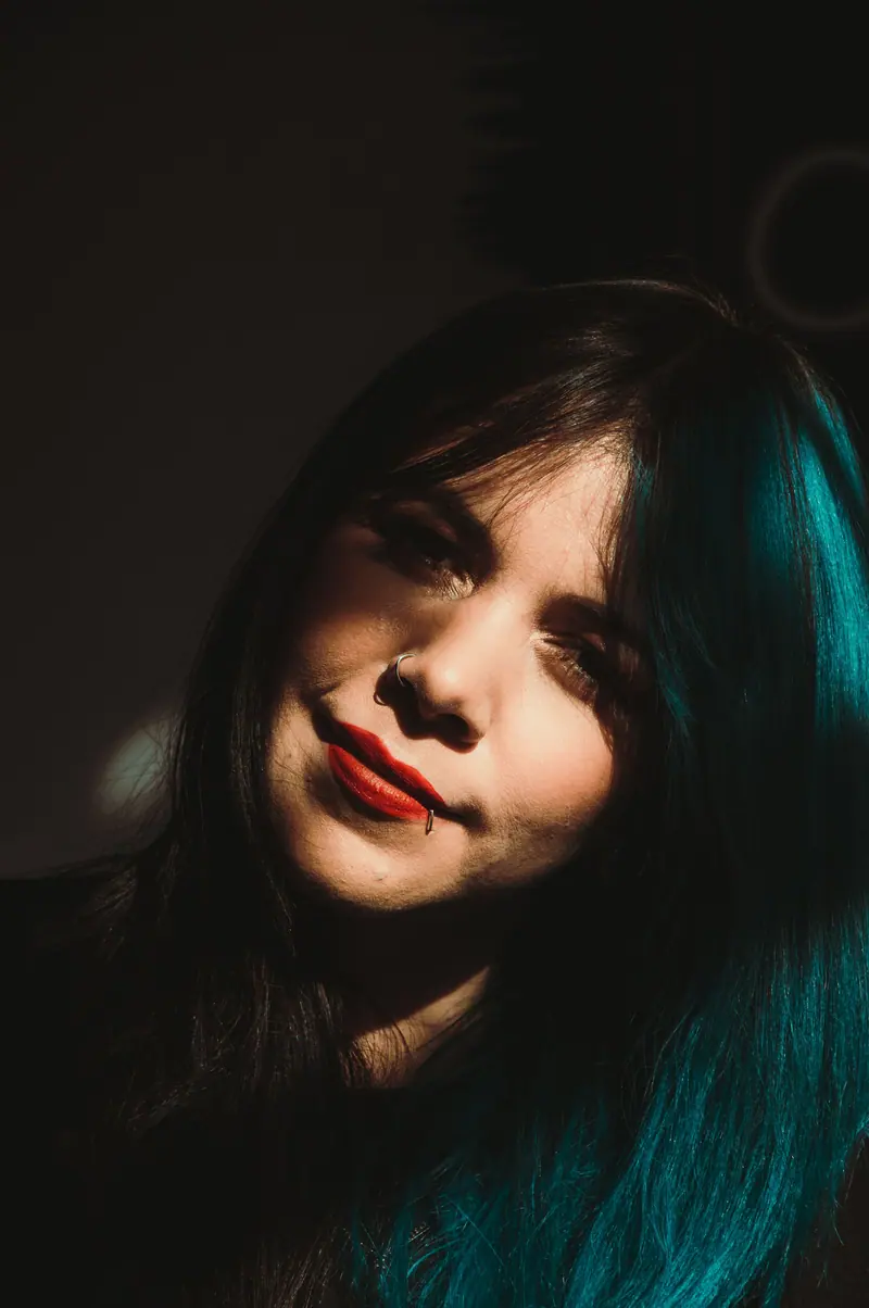 Blue hair and red lipstick in dramatic light