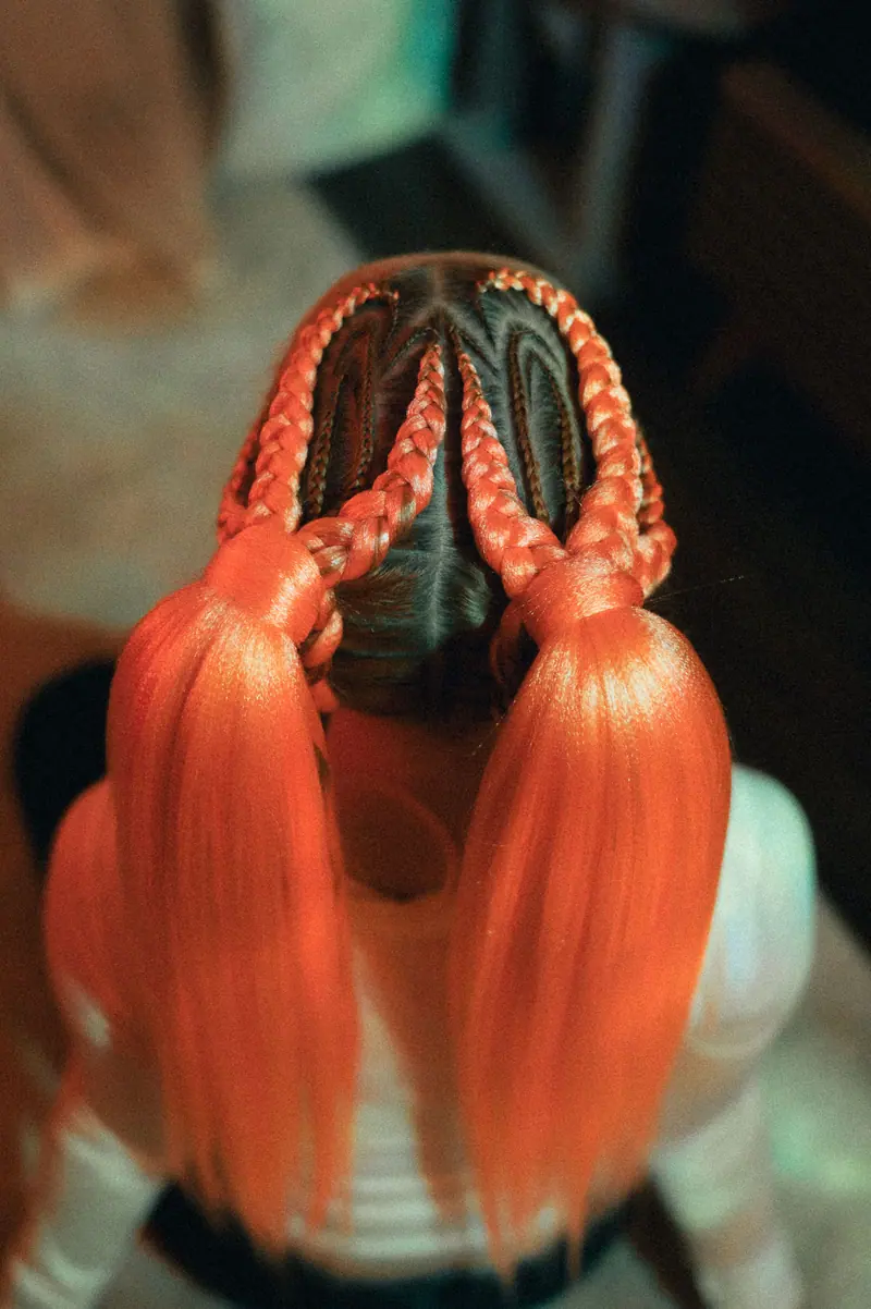 Orange braids in a sculptural pattern