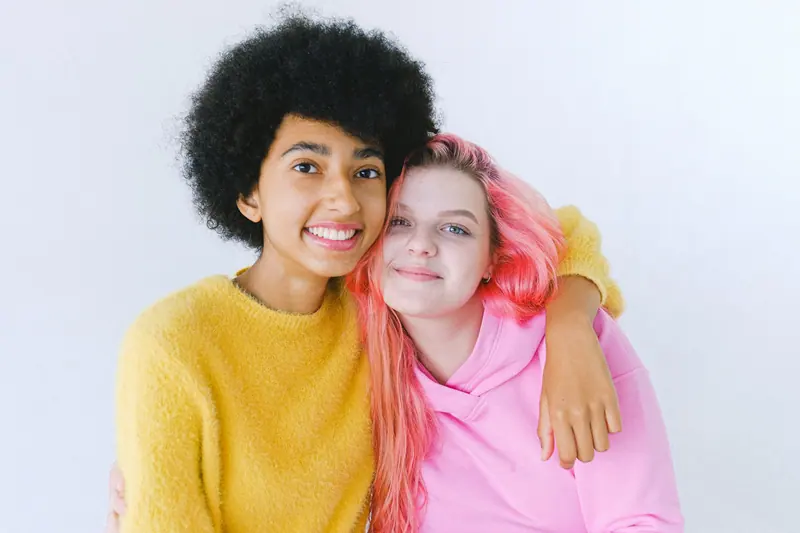 Friends with pink hair and an afro