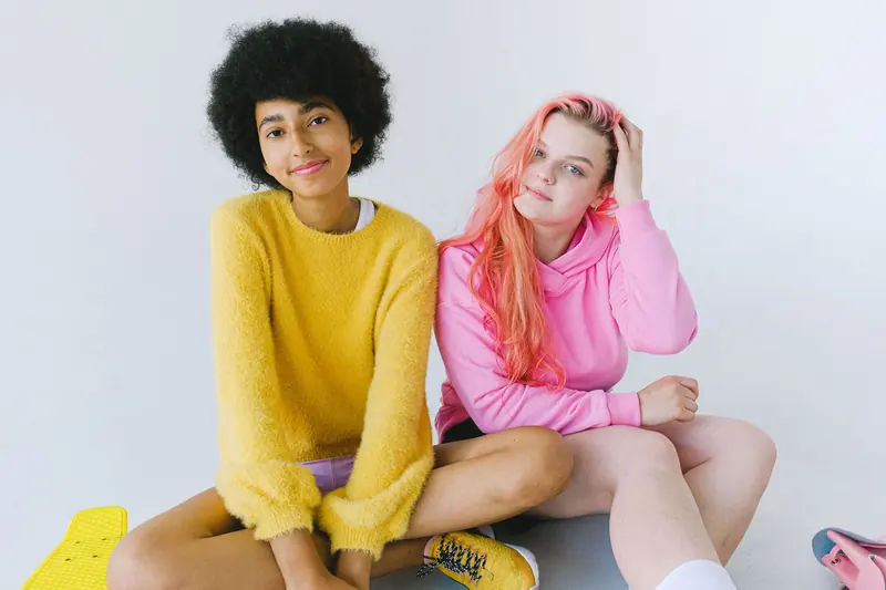 Pink hair and a yellow sweater on white