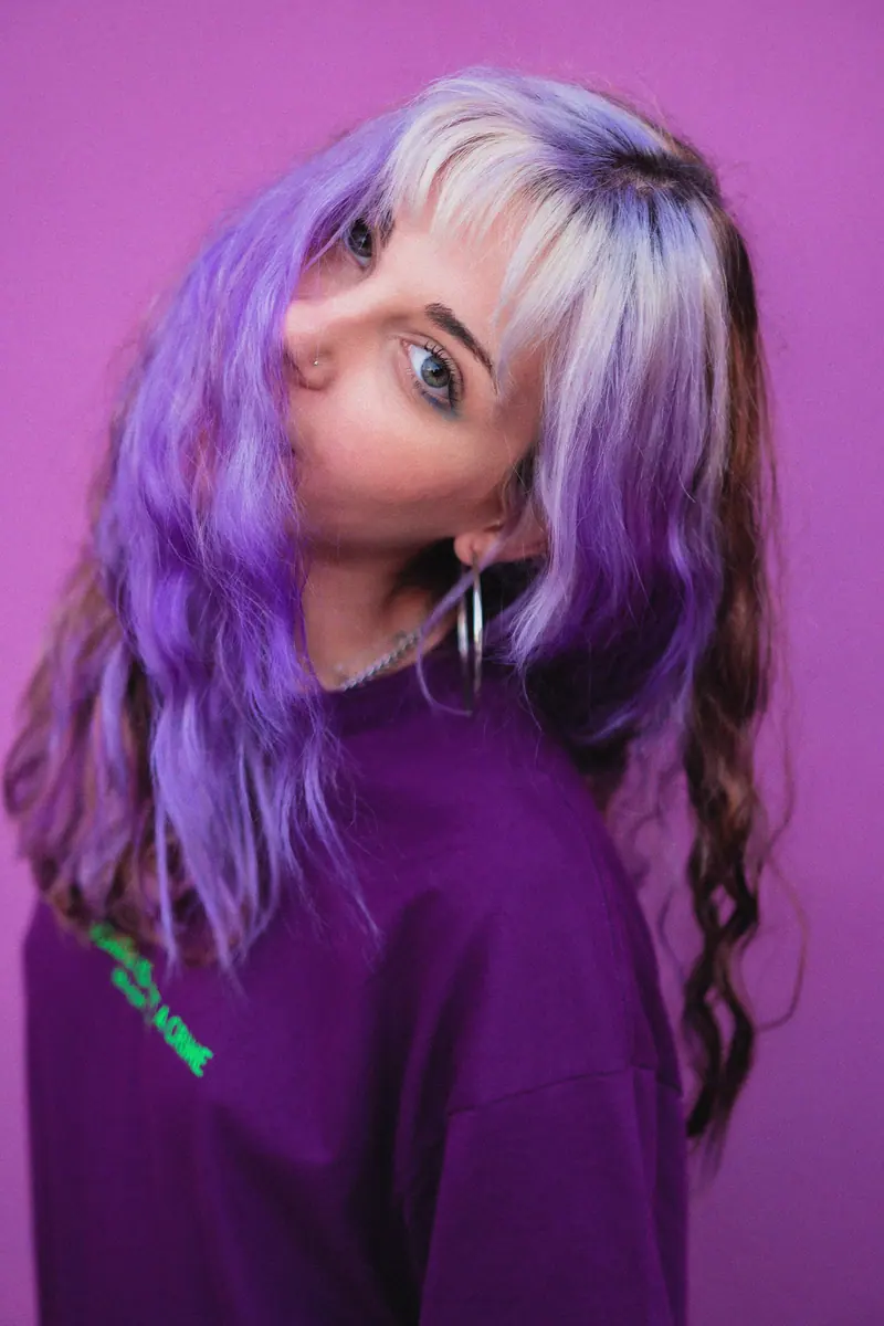 Purple hair on a matching backdrop
