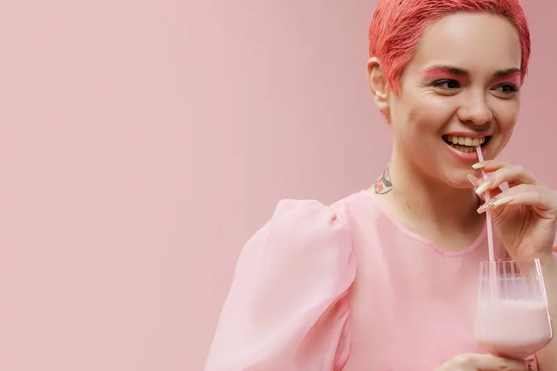 Pink-haired client with a strawberry milkshake