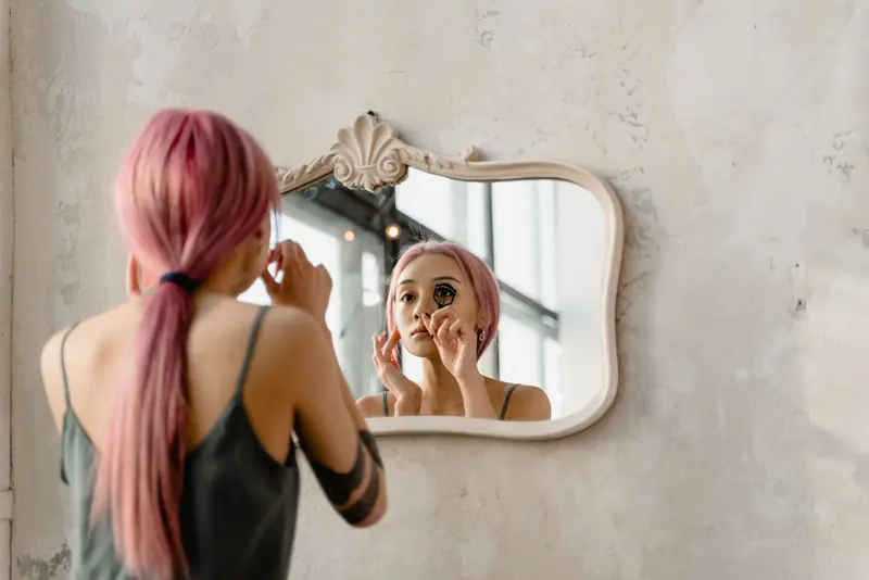 Pink-haired client at the mirror