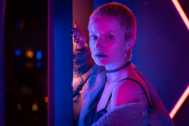 Pink pixie between blue and red neon