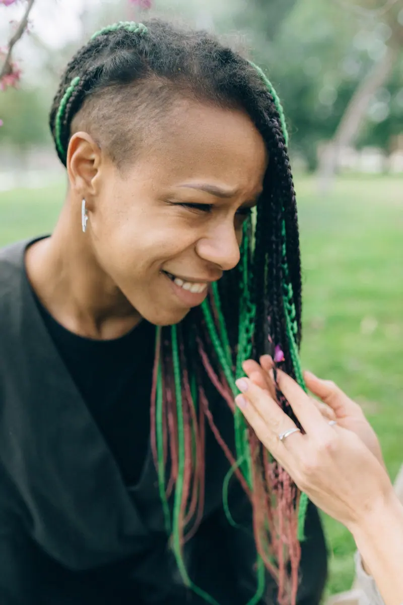 Green-tipped braids and a smile