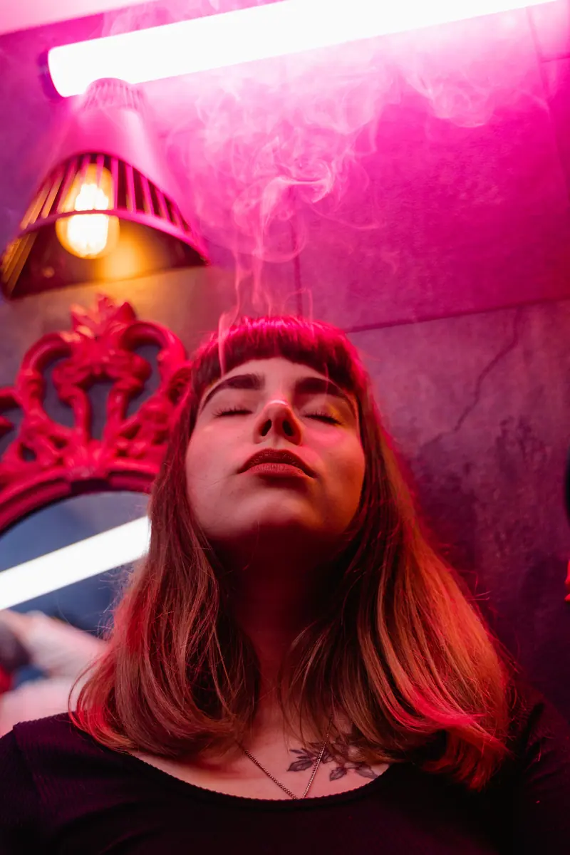 Pink smoke and a lamp-lit red room