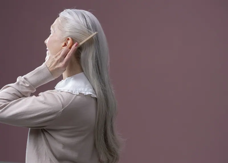Long silver hair on mauve