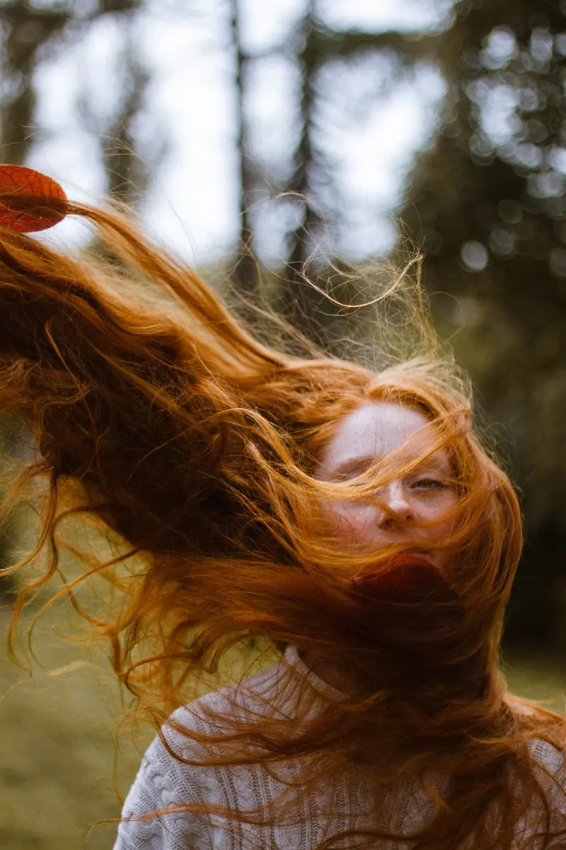 Long red hair caught in the wind