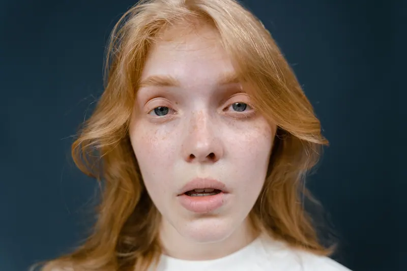 Red-gold hair and freckles in close-up