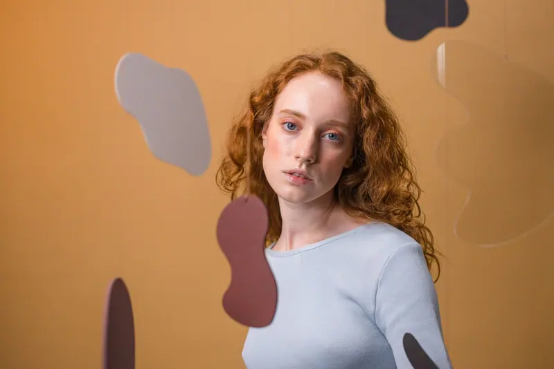Copper ringlets against an ochre wall
